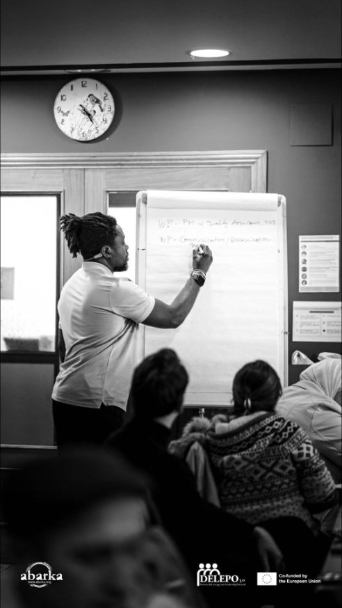 Clotaire writing work packages on a flipchart in front of participants