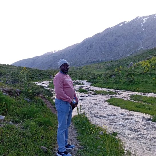 Clotaire standing by a mountain river